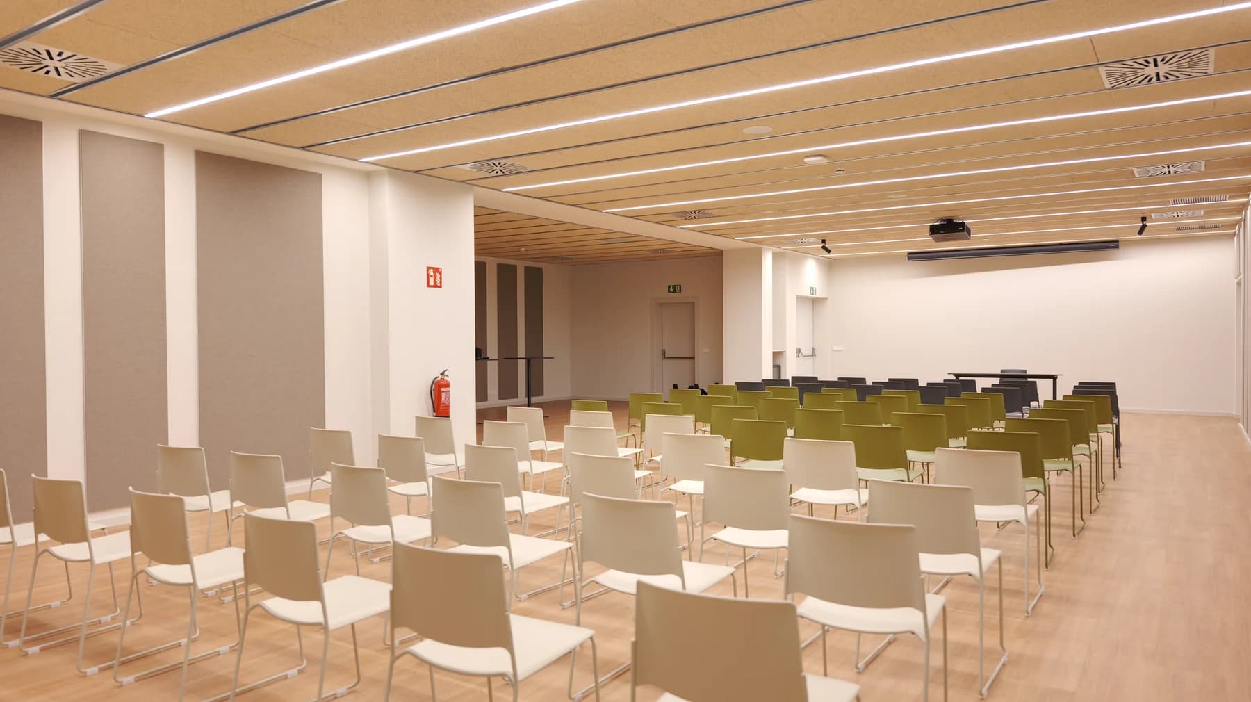 Rows of chairs facing the presentation area in the venue auditorium